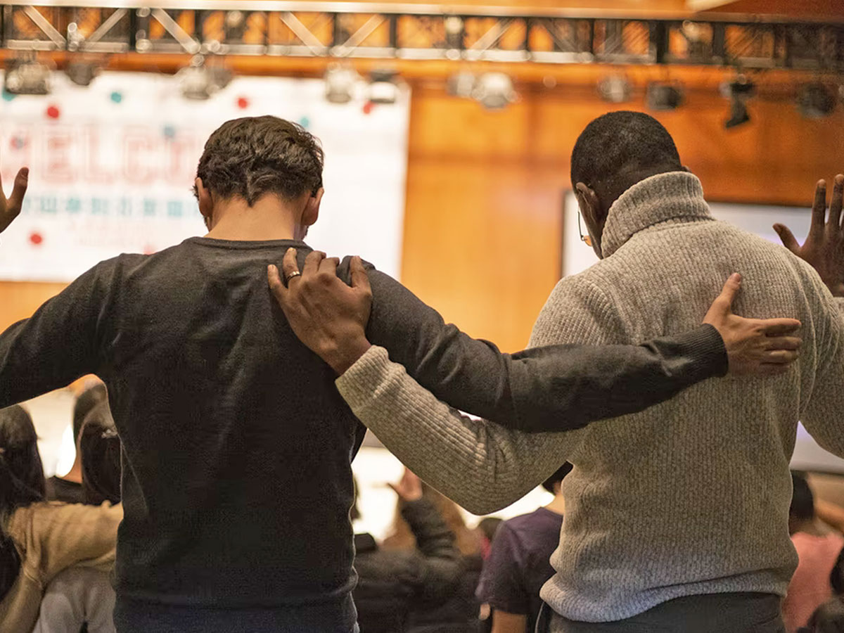 Image of two men praying together
